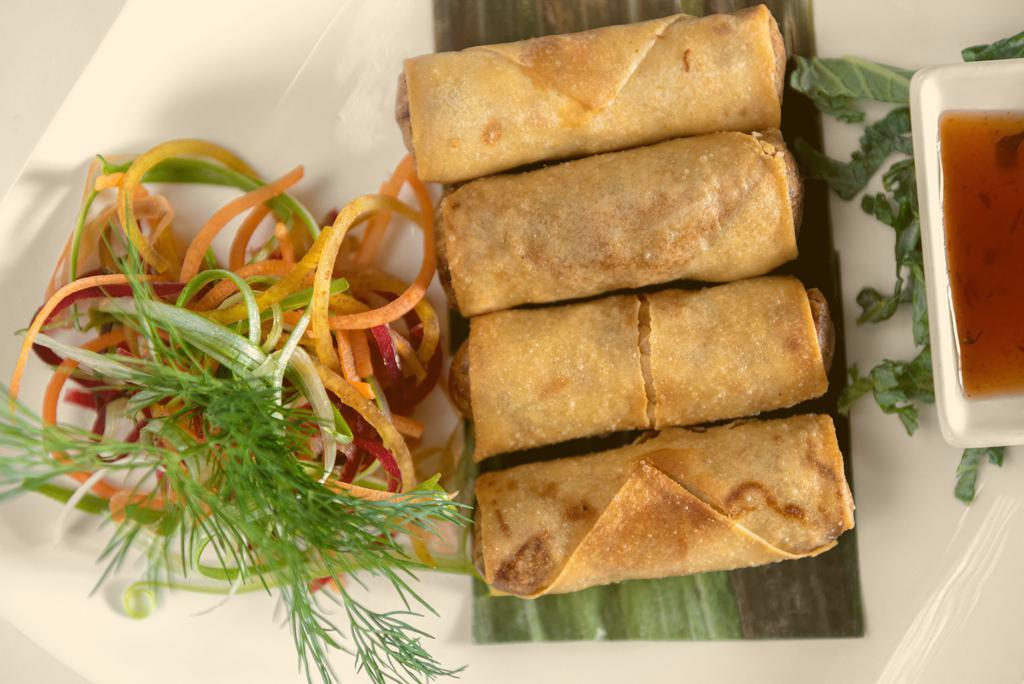 Spring Roll · Carrot, cabbage, garlic, taro and glass noodles in a crispy spring roll wrapper, served with housemade palm dipping sauce.