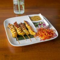 Thai Satay · Perfectly grilled chicken skewers marinated in red curry paste, soy sauce, and coconut milk,...