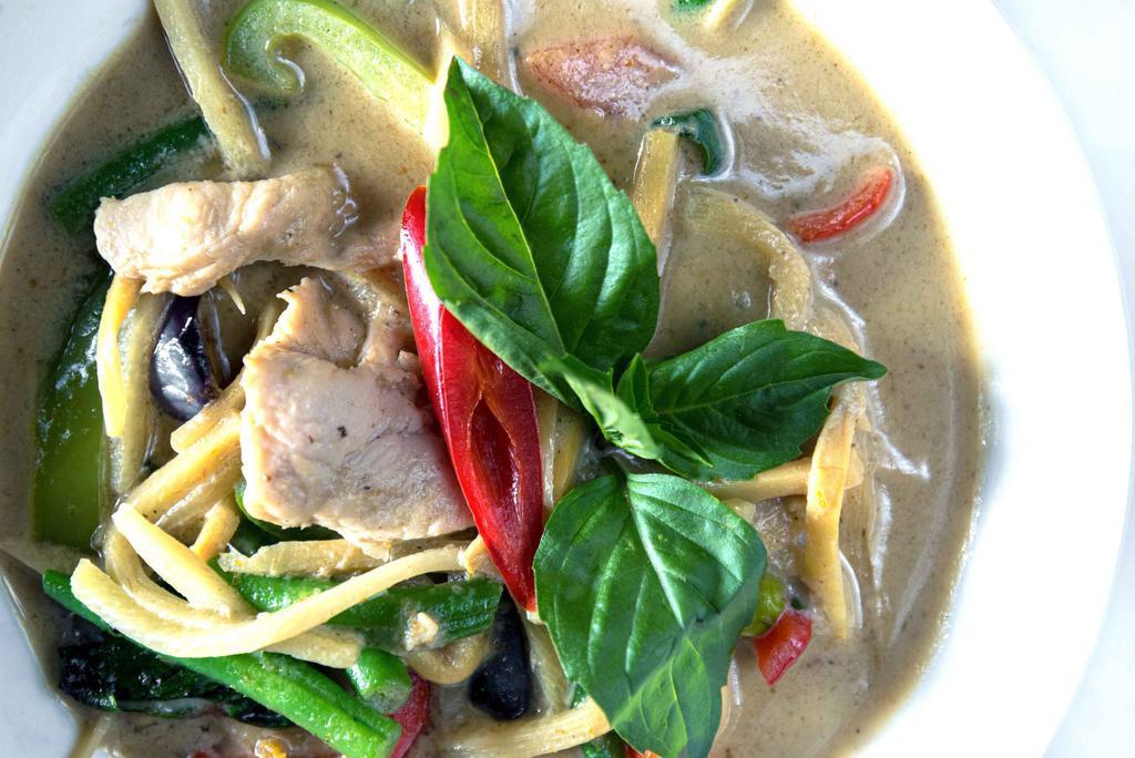 Green Curry · Coconut milk, string beans, bamboo shoots, eggplant, and Thai basil in a colorful green curry sauce from a blend of Asian spices and herbs.