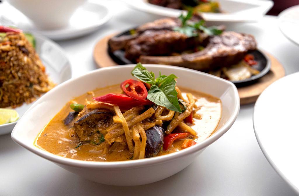 Red Curry · Coconut milk, bamboo shoots, eggplant, green and red bell peppers and Thai basil in a colorful red curry sauce from a blend of Asian spices and herbs.