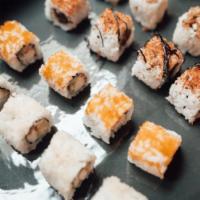 Ultraman Sushi Roll · Shrimp tempura, salmon, shallot, and avocado. Topped with shrimp tempura, masago, sesame see...