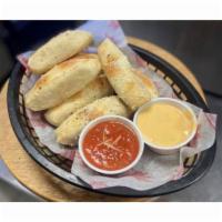 Breadsticks · Served with Housemade Queso and Marinara Sauces.
