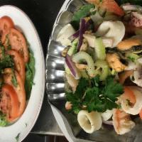 Seafood Salad Dinner · Octopus, calamari, shrimp, fresh celery, tomatoes, onions, lemon, garlic, olive oil, and a t...