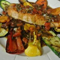 Grilled Salmon Dinner · Served with grilled vegetables, topped with a tomato capers vinaigrette sauce.