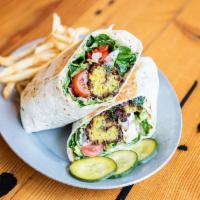 Falafel Wrap · Hummus, cucumber, romaine, tomato, red onion, Mama Lil's peppers, dill pickles, pomegranate-...