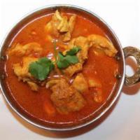 Chicken Curry · Boneless chicken, onion and tomato-based sauce and Indian spices.