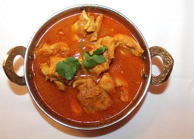 Chicken Curry · Boneless chicken, onion and tomato-based sauce and Indian spices.