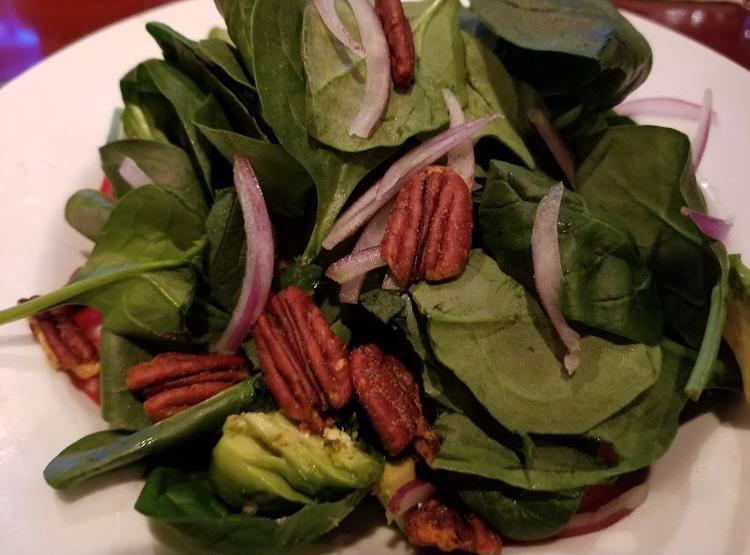 Baby Spinach Salad · Baby spinach, shaved Bermuda onion, avocados, Campari tomatoes, spiced pecans, chile-lemon dressing on the side. Add-ons for an additional charge. Gluten-free.
