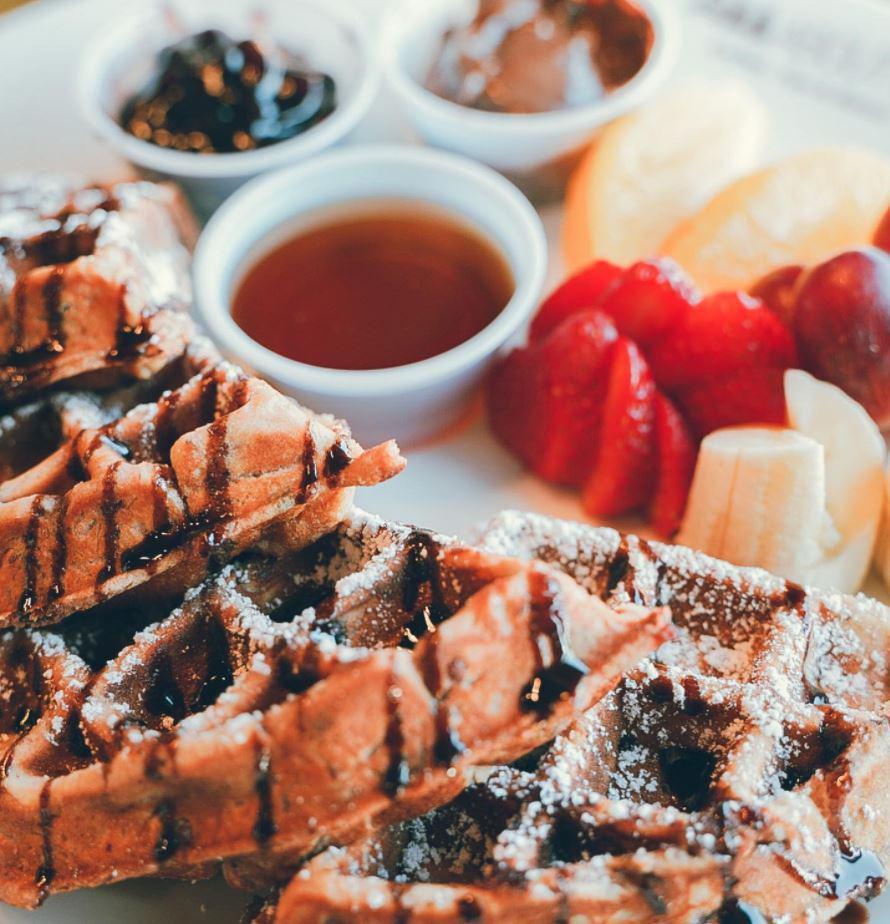 Breakfast Waffle · Homemade fresh Belgian style waffle. Comes with a side of maple syrup and fresh fruits. (Banana, strawberry, grapes, and orange. )