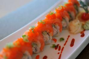 All About Salmon Roll · All About Cha's original sushi roll. A california roll base. Topped with sushi salmon and ma...