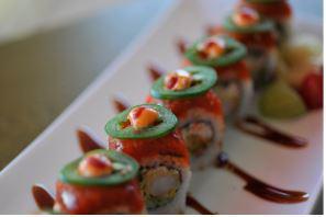All About Fire Roll · All About Cha's original sushi roll. A California roll with tempura shrimp inside. Topped with spicy tuna, jalapeño slices, and sesame seed. Sauce: eel sauce, spicy mayo, and Sriracha. Comes with a cup of miso soup.