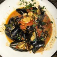Mussels Marinara · Prince edward island mussels sauteed in marinara served hot or sweet over linguine.