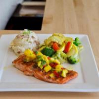 Grilled Salmon · Grilled blackened salmon served with mashed potatoes and vegetables.