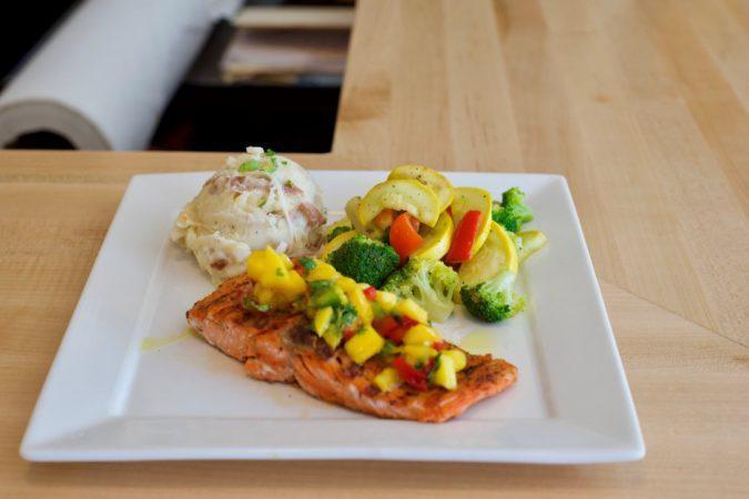 Grilled Salmon · Grilled blackened salmon served with mashed potatoes and vegetables.