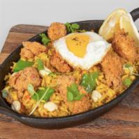 Arroz con Pollo · Venezuelan style creamy rice with fried and grilled chicken, fried egg, and green peas. Add-...