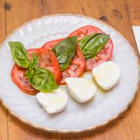 Mozzarella di Bufala · Sliced vine ripe tomatoes and fresh basil.