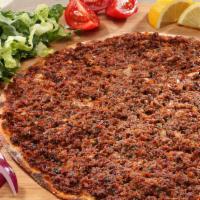 Wrapway's Lahmajoun · Lahmajoun is a round, thin piece of dough topped with ground beef, minced vegetables, and he...