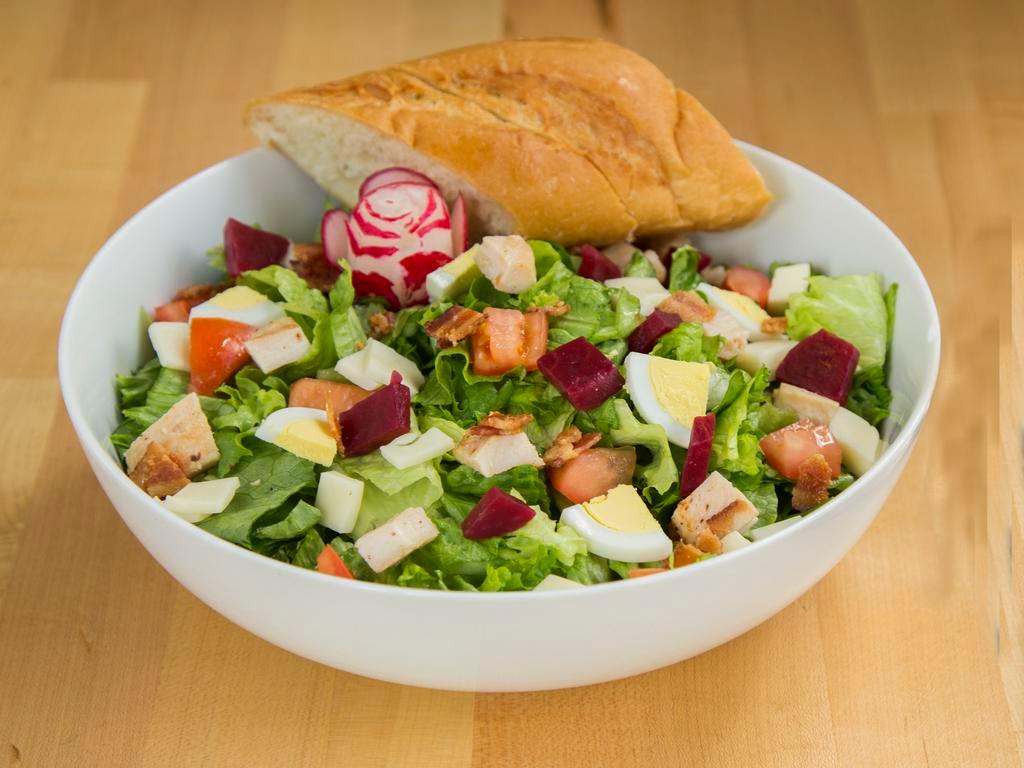 Gotham Salad · Green leaf lettuce, chicken, bacon, provolone, hard boiled egg, tomatoes and beets tossed with our 1,000 island dressing.