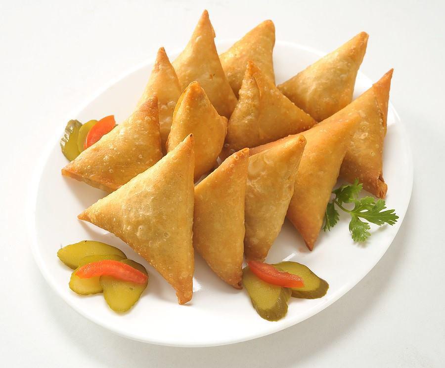 1 Piece Chicken Samosa · A fried pastry with a savory chicken and potato filling.
