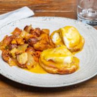 Eggs Benedict · Poached eggs, canadian bacon, buttermilk biscuit, old bay hollandaise, home fries