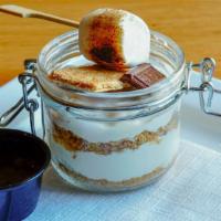 S’mores Cheesecake Jar · Layers of crushed graham crackers and marshmallow fluff cheesecake filling garnished with a ...