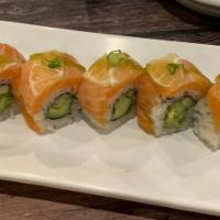 Yuzu Salmon Roll · Cucumber avocado roll topped with salmon and lemon.