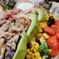 Cobb Salad · Mixed greens topped with chopped tomato, avocado, egg, bleu-cheese crumbles, corn, bacon and...