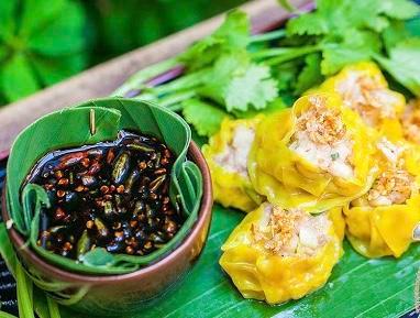 Kanom Jeeb · Thai dumplings. Steamed ground shrimp and chicken served with soy bean sauce.