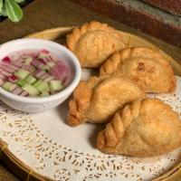 Curry Puffs · Stuffed with ground chicken, potato and Thai curry paste served with cucumber sauce.