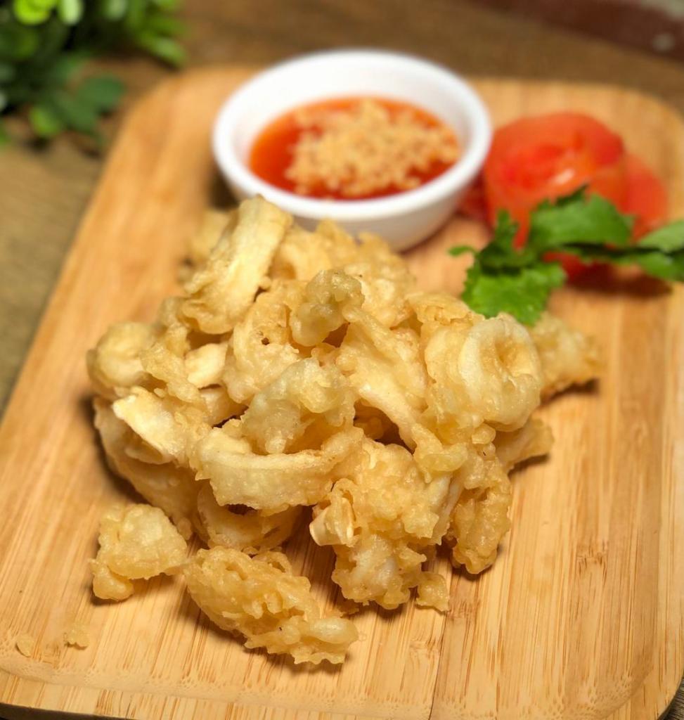 Crispy Calamari · Fried tempura golden calamari served with sweet chili sauce and crushed peanut. 