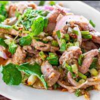 Grilled Pork Salad · Grilled tender pork, red onion, cucumber, scallion, cilantro with spicy lime dressing.