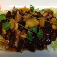 Duck Tamarind · A 1/2 roasted duck topped with tamarind sauce, pineapple and cashew nuts. Served with steame...