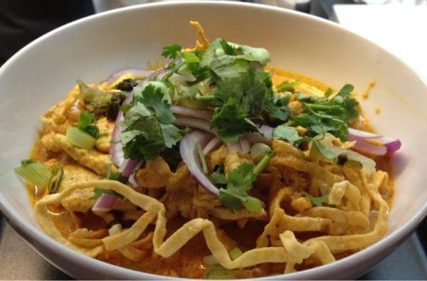 Kow Soy Kai Specialty · One of the most popular northern Thailand dishes crispy yellow noodle in coconut milk in yellow curry with chicken, sprinkled with slice red onion and scallion. Spicy.