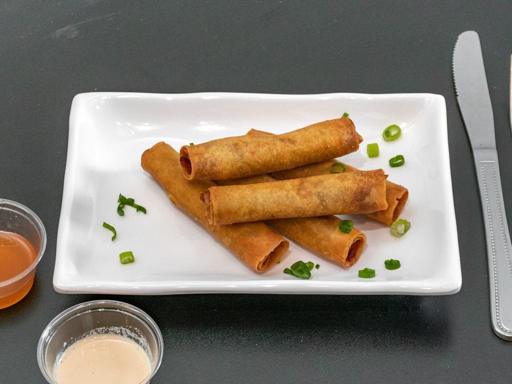 Lola's Lumpia · 5 pieces. Filipino style egg rolls filled with ground beef, carrots and green onion. Served with our sweet chili sauce and sisig sauce.