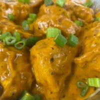 Afghani Chicken Momos · 8 pcs of Shallow fried Momos tossed in special creamy sauce are bite-size dumplings with chi...