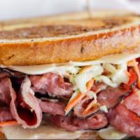 Almost Reuben Sandwich · Grilled pastrami, coleslaw, thousand island, and melted Swiss cheese on marbled rye bread.