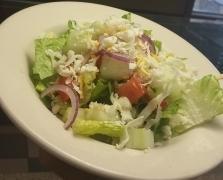 House Salad · A small house salad with lettuce, tomato, red onion, cucumber, and mozzarella cheese with ch...
