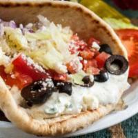Veggie Gyro · Cucumber sauce, lettuce, tomatoes, feta cheese, sliced black olives and red onions served in...