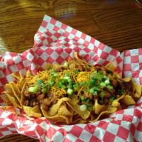 BBQ Style Frito Pie · Served with pinto beans, topped with cheddar cheese, sour cream and chives.