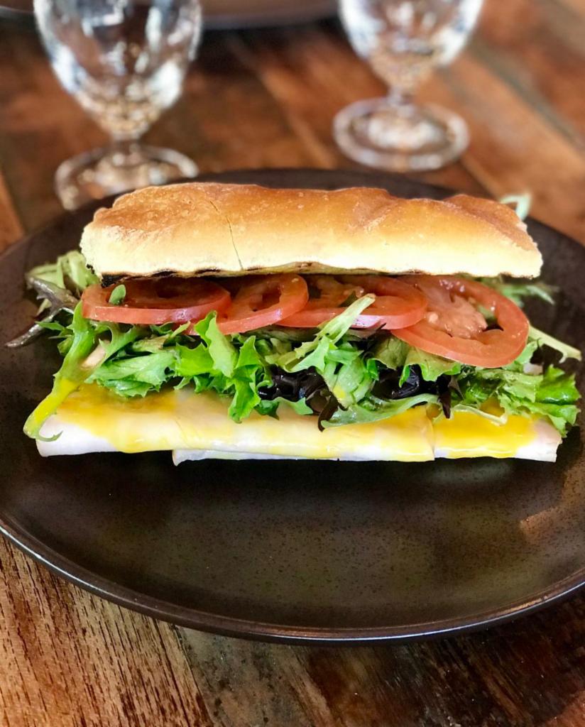 Turkey Sandwich on Ciabatta · Smoked Turkey Slices with our homemade honey mustard sauce served with mixed greens and tomatoes.