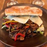 Steak Sandwich on Ciabatta · Char-grilled steak sandwich served with mozzarella cheese, sauteed mushrooms, mixed peppers,...
