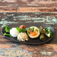 Small Meze Platter · Hummus, babaganoush, grape leaves, stuffed fig, spicy vegetables.