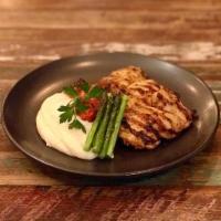 Chicken Chops · Grilled boneless chicken thighs served with cheesy mashed potatoes, asparagus and chicken au...