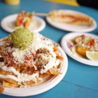 Not Nachos · Homemade corn tortilla chips topped with beans, cheese, sour cream, guacamole, onions, cilan...