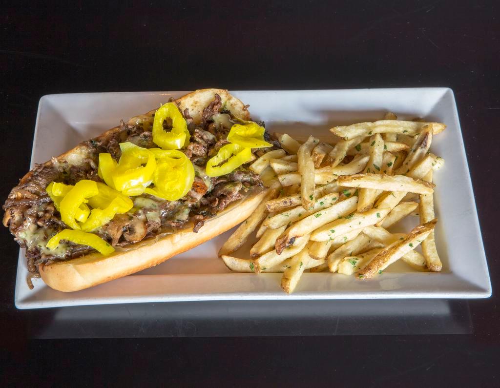 Philly Argentina · Chimichurri marinated shaved rib-eye, grilled onion, cremini mushroom, provolone cheese, sweet banana pepper, chimichurri aioli, house-made roll, served with hand-cut fries. (fries fried in soy oil)
