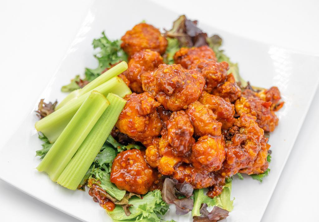 Kraken Cauliflower Bites (GF/NF) · Battered Cauliflower florets marinated in our house made crackin sauce, piled atop spring mix. Served with celery and ranch dressing.
