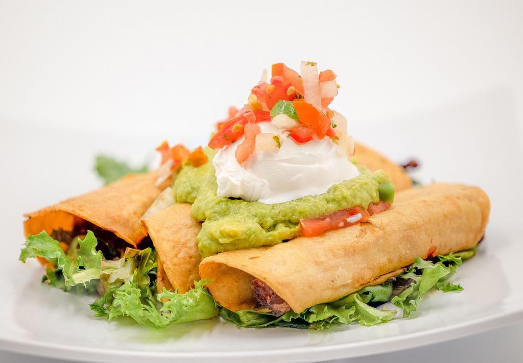 Flautas (GF/NF) · Three rolled and fried corn tortillas filled with seasoned chick'n, topped with shredded lettuce, guacamole, sour cream and pico.