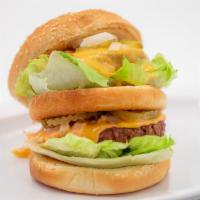 Double Decker · Two vegan patties with thousand island, pickles, lettuce, and cheese sauce on a sesame bun.