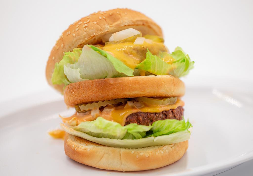 Double Decker · Two vegan patties with thousand island, pickles, lettuce, and cheese sauce on a sesame bun.