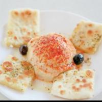 Hummus · Spread made of chickpeas, tahini, garlic, lemon, and olive oil. Served with grilled pita bre...